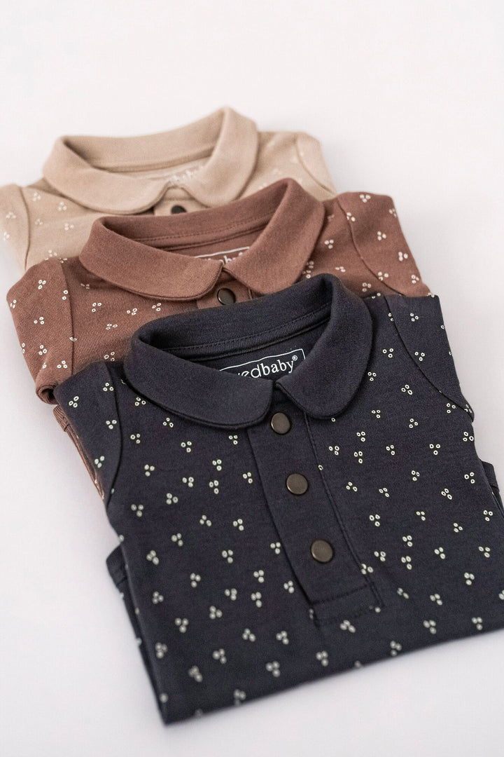 Child wearing Organic Polo Bodysuit in Charcoal Dots.