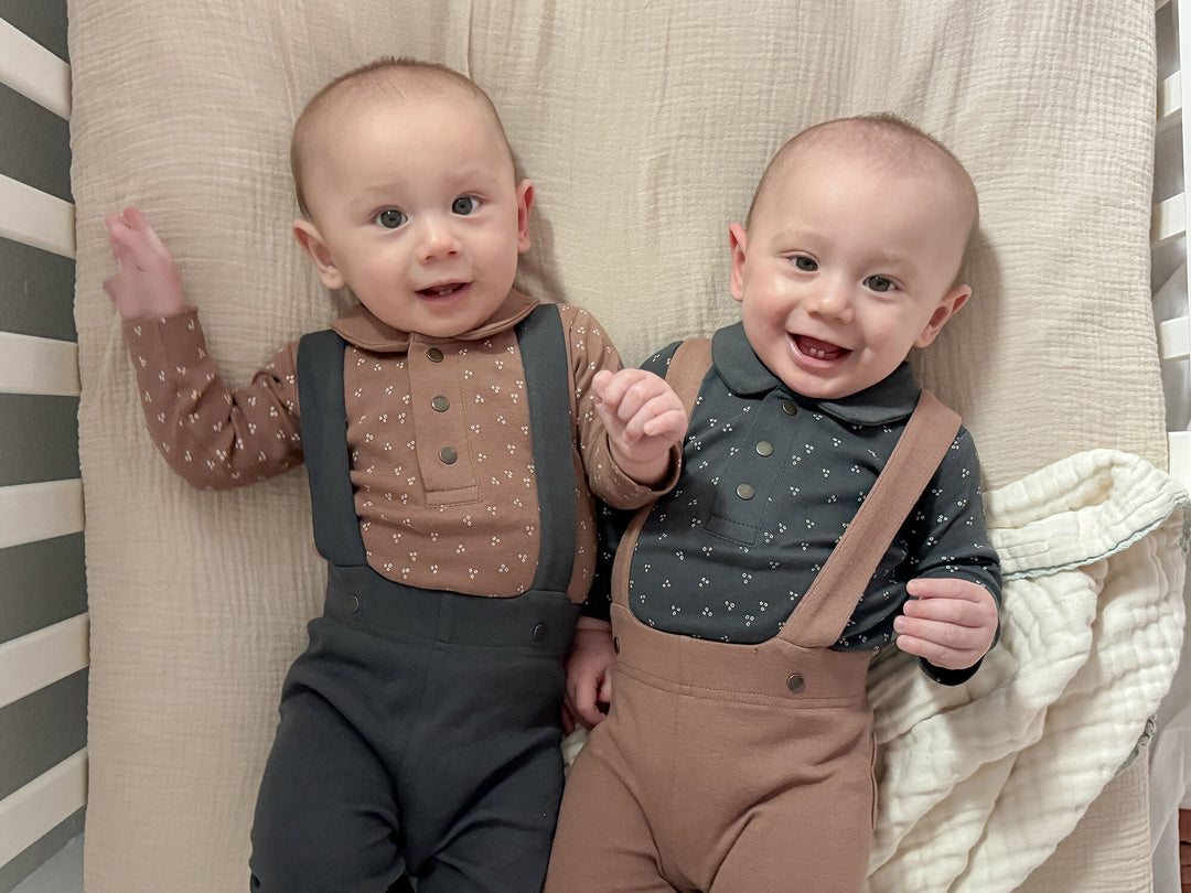 Child wearing Organic Polo Bodysuit in Charcoal Dots.