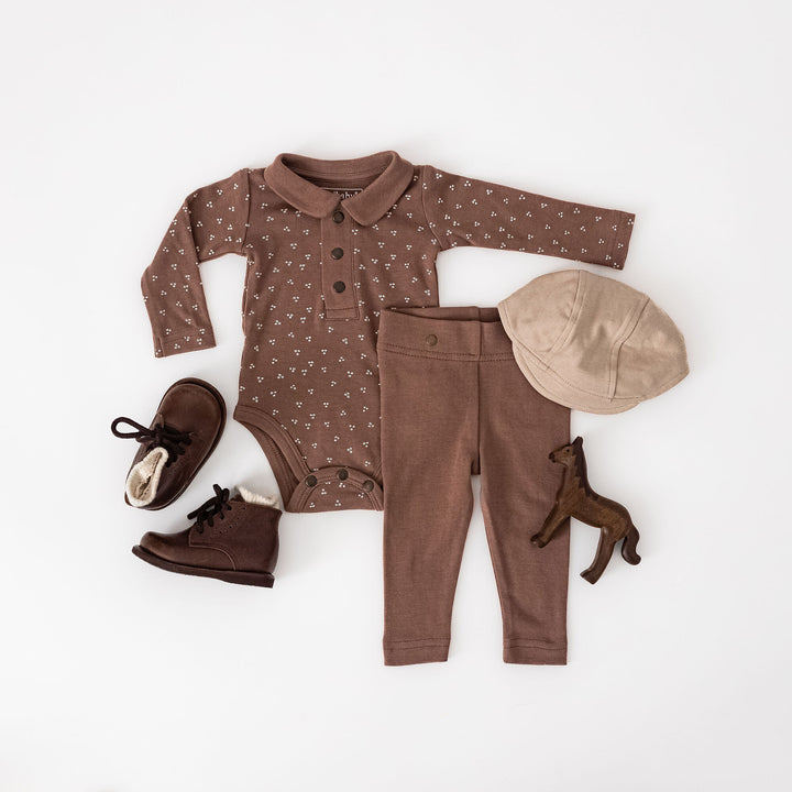 Child wearing Organic Polo Bodysuit in Latte Dots.