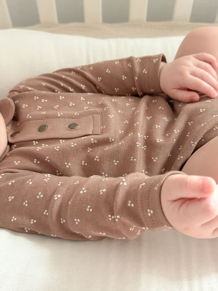 Child wearing Organic Polo Bodysuit in Latte Dots.