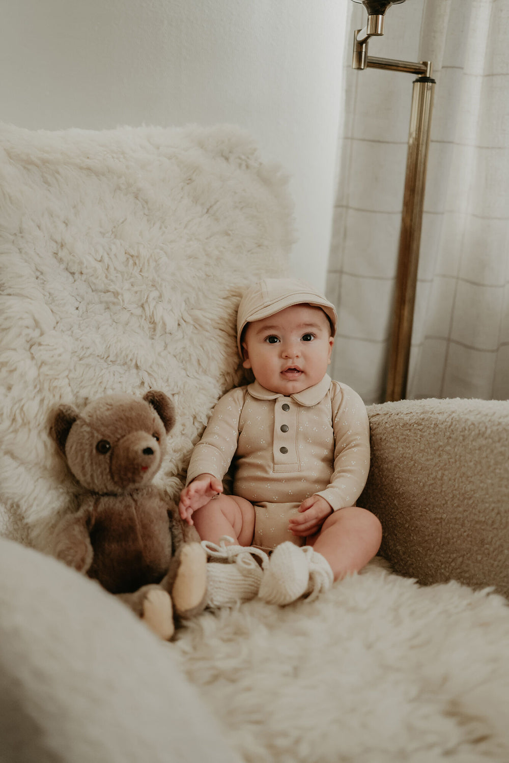 Child wearing Organic Polo Bodysuit in Oatmeal Dots.