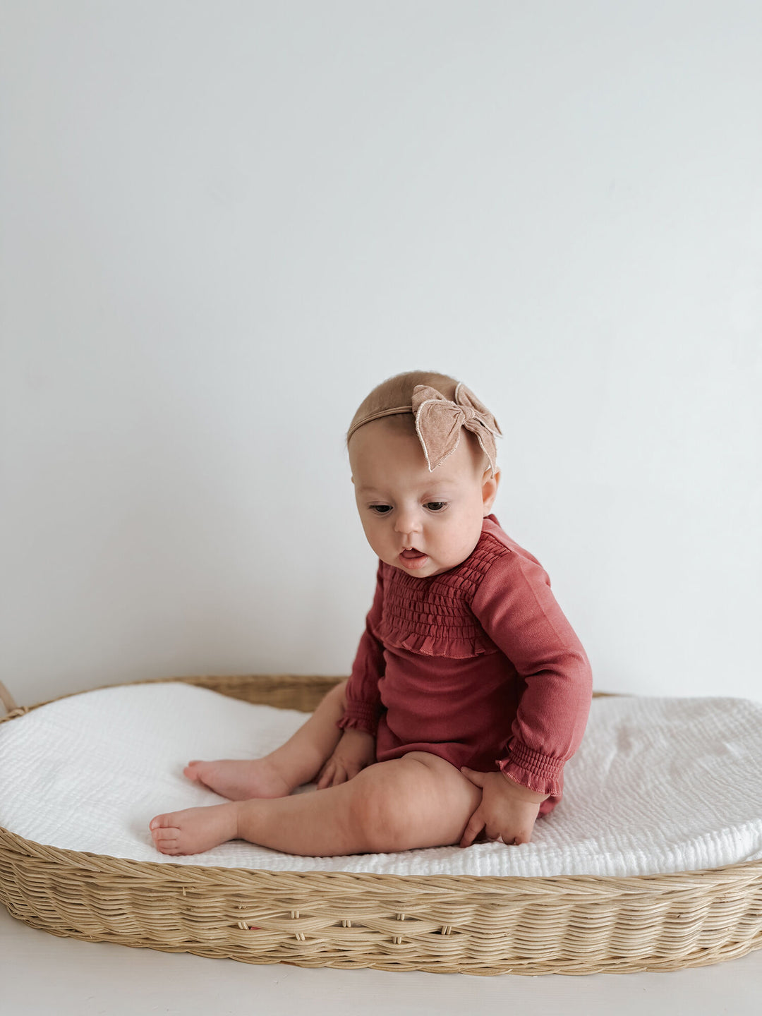 Child wearing Organic Smocked Chest Bodysuit in Appleberry.