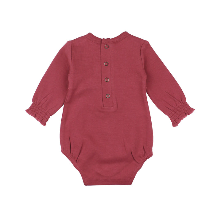 Back view of Organic Smocked Chest Bodysuit in Appleberry, a dark, dusky pink color.