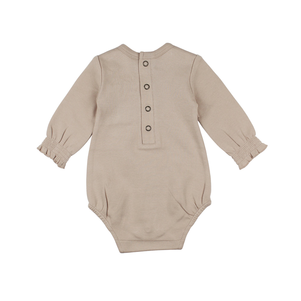 Back view of Organic Smocked Chest Bodysuit in Oatmeal, a light tan color.