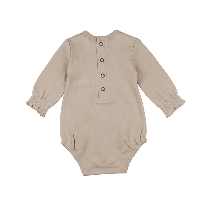 Back view of Organic Smocked Chest Bodysuit in Oatmeal, a light tan color.