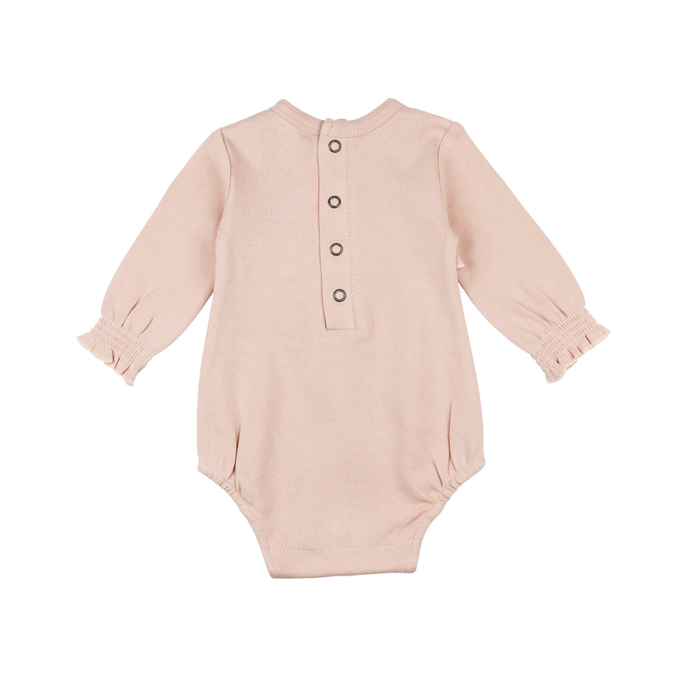 Back view of Organic Smocked Chest Bodysuit in Rosewater, a light pink color .