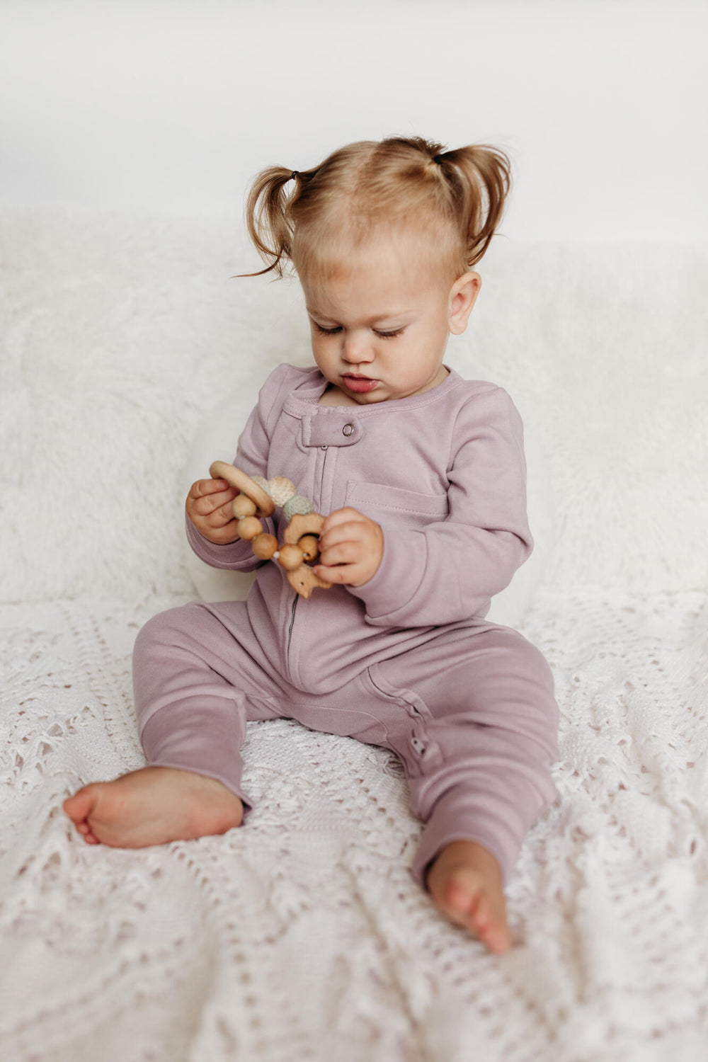 Child wearing Organic Footless 2-Way Zipper Romper in lavender 