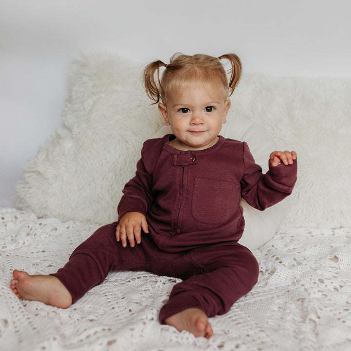 Child wearing Organic Footless 2-Way Zipper Romper in plum