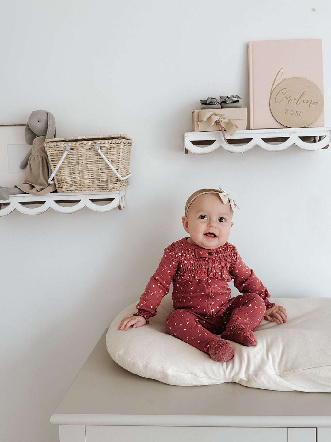 Child wearing Organic Smocked Zipper Footie in Appleberry Dots.