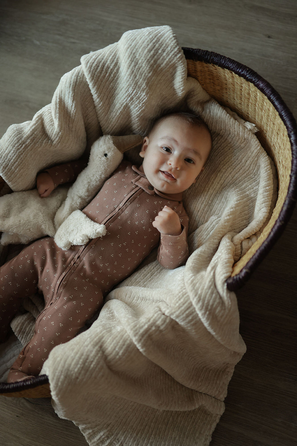 Child wearing Organic Polo Zipper Footie in Latte Dots.