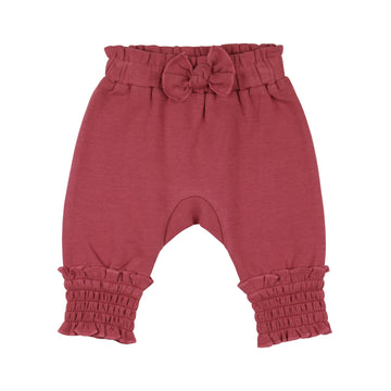 Organic Smocked Bubble Pants in Appleberry, a dark, dusky pink color.