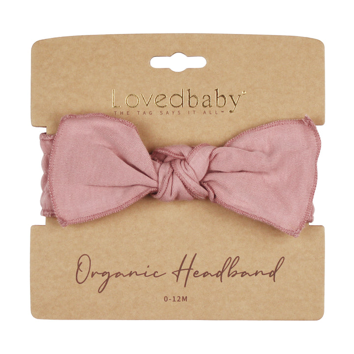 flat image of mauve headband on cardboard packaging