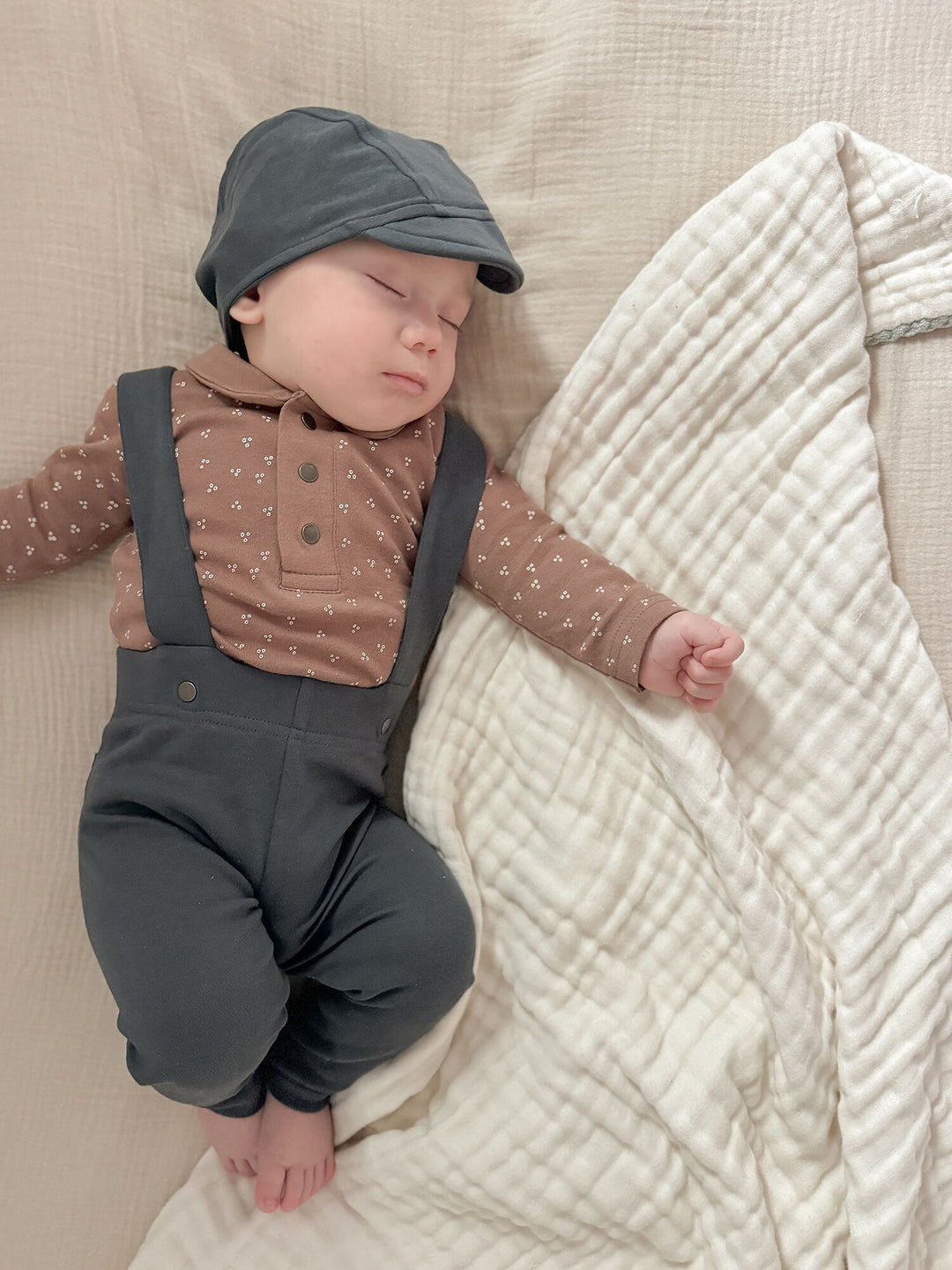 Child wearing Organic Suspender Pant in Charcoal.