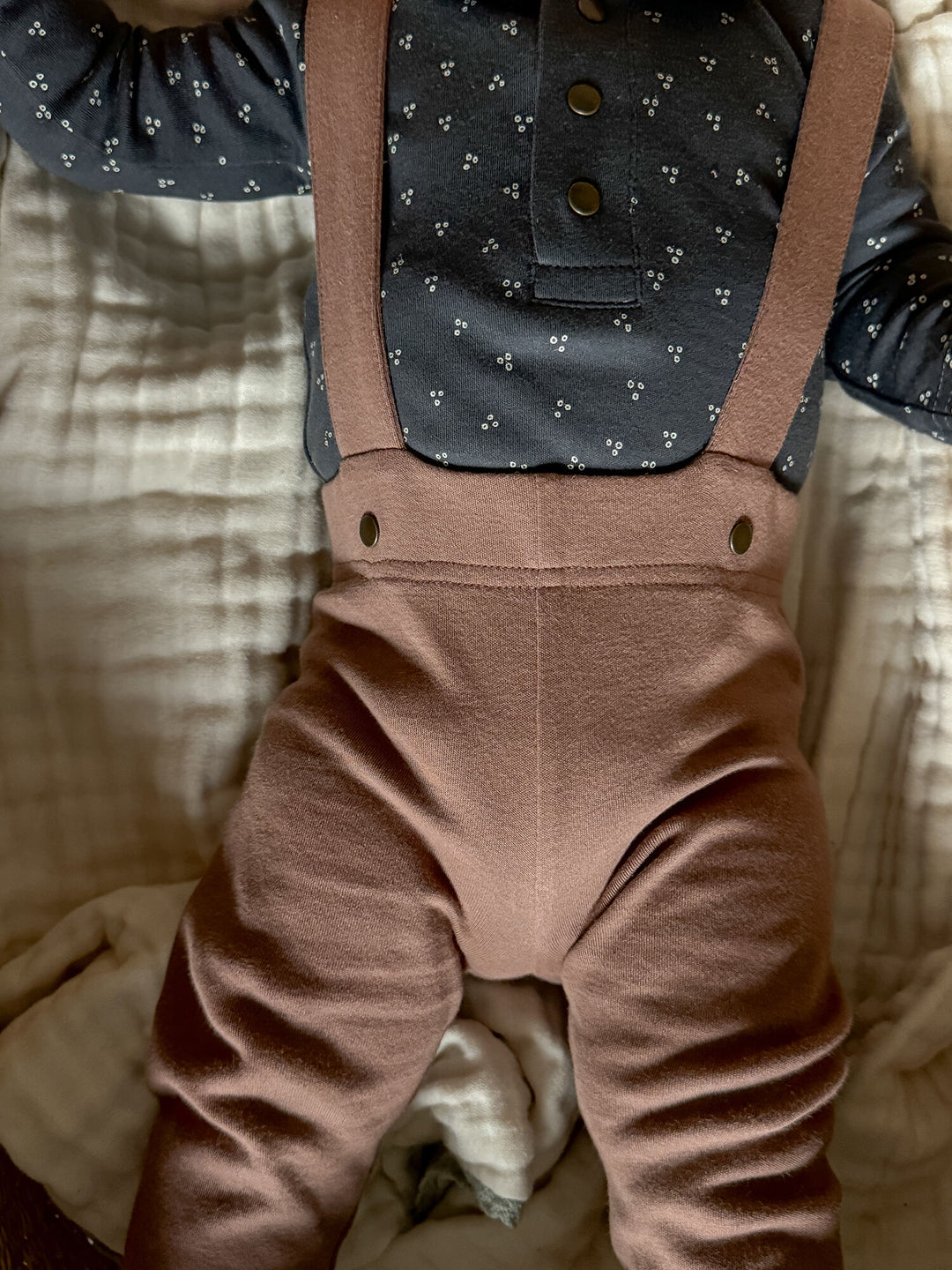 Child wearing Organic Suspender Pant in Latte.