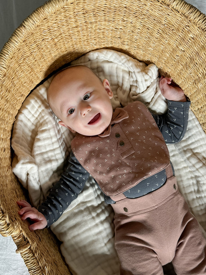 Child wearing Organic Double-Layer Bowtie Bib in Latte Dots.