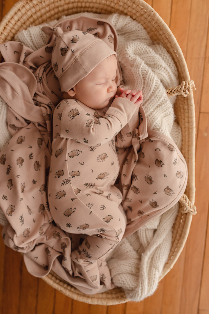 Child wearing Organic Blanket in Prickles.