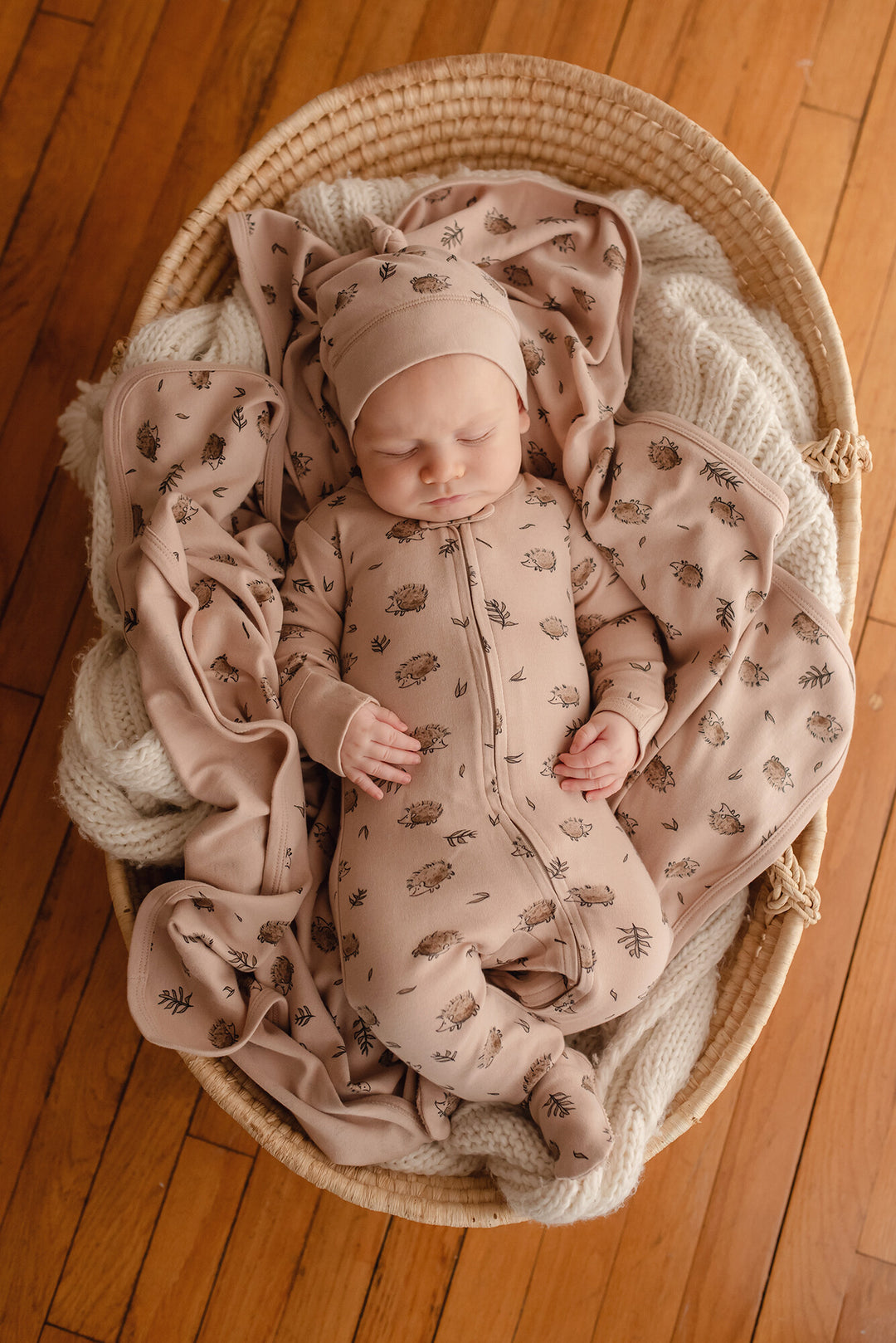 Child wearing Organic Blanket in Prickles.