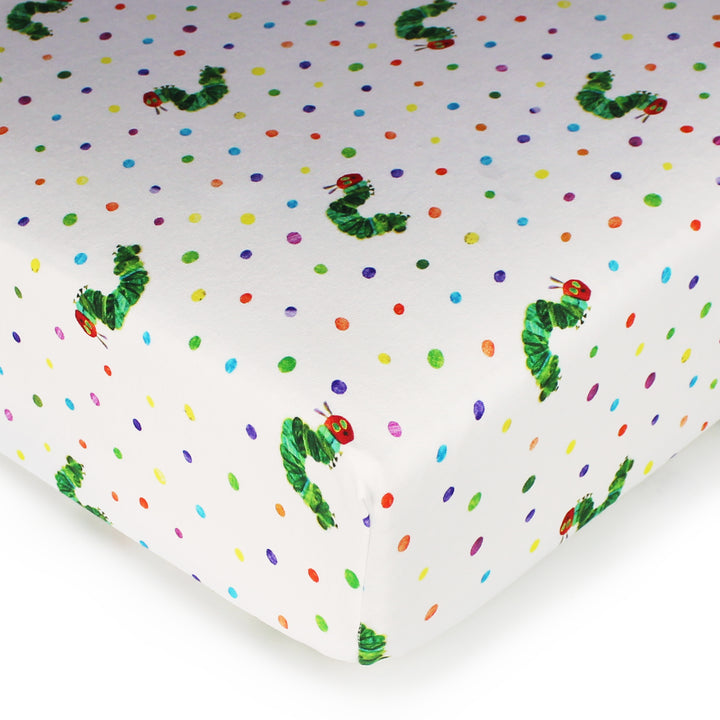 cropped corner shot of caterpillar print crib sheet on mattress