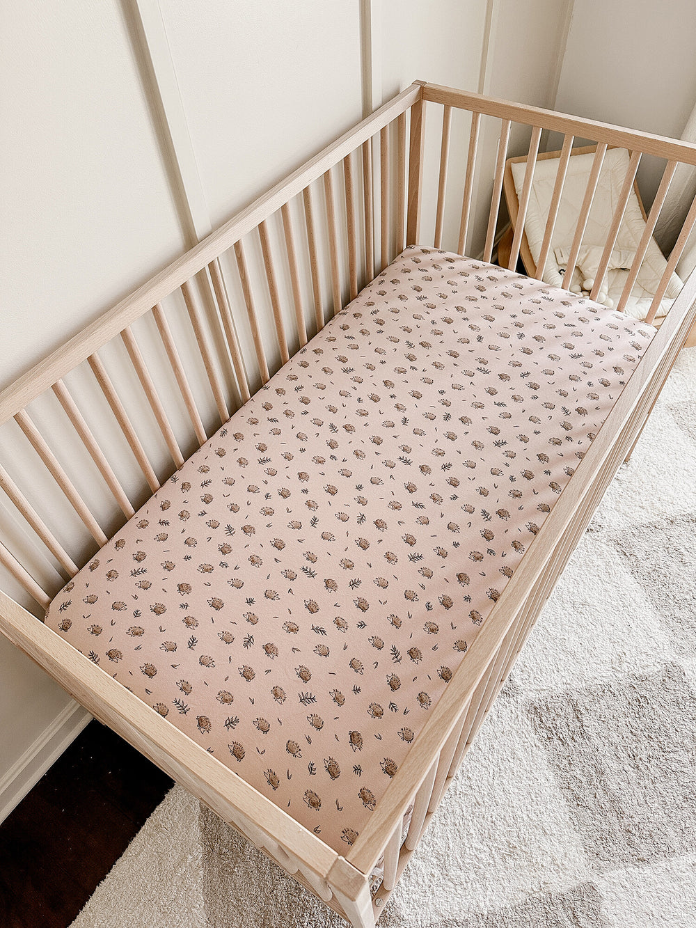 Child wearing Organic Crib Sheets in Prickles.