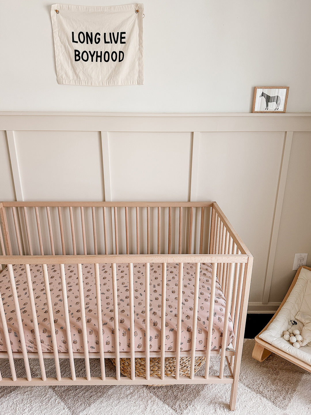 Child wearing Organic Crib Sheets in Prickles.