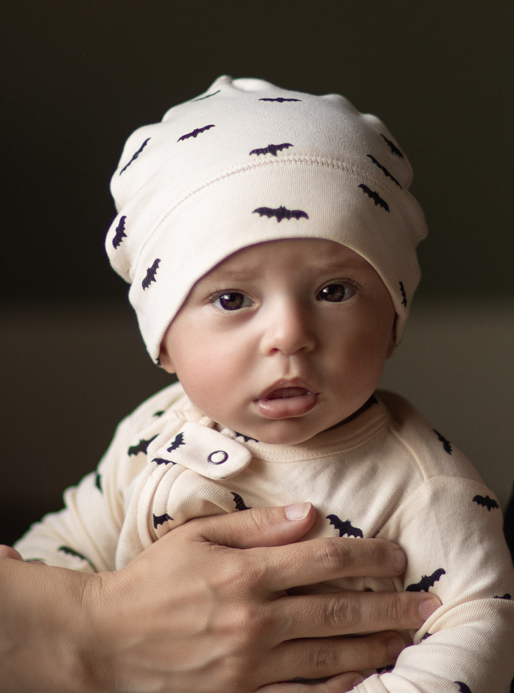 Child Wearing Organic Banded Top-Knot Hat in Boos.