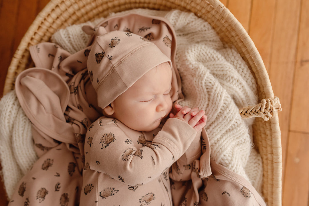 Child wearing Organic Banded Top-Knot Hat in Prickles.