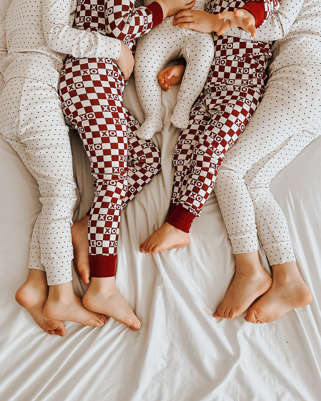 Child wearing Organic 2-Way Zipper Footie in Crimson Mini Hearts.