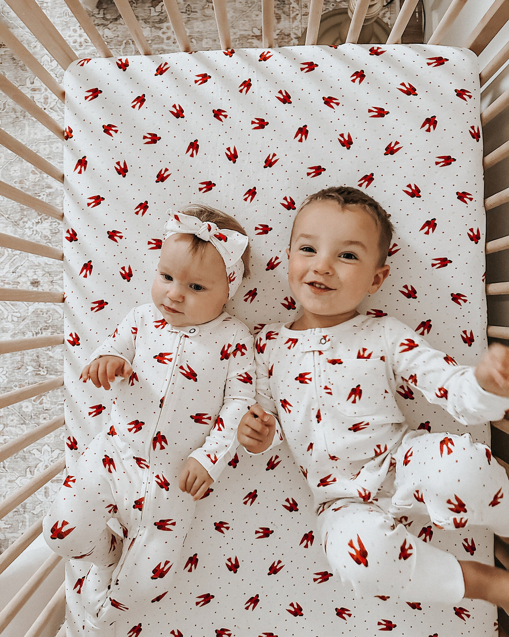 Child wearing Organic 2-Way Zipper Footie in Red Bird.