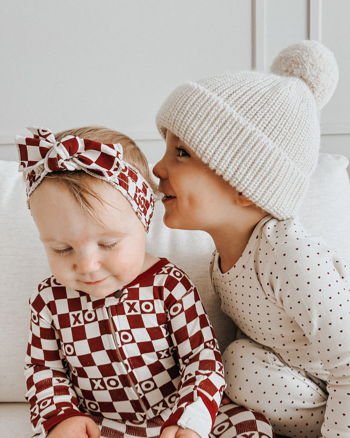 Child wearing Organic Smocked Headband in Crimson XO Checker.