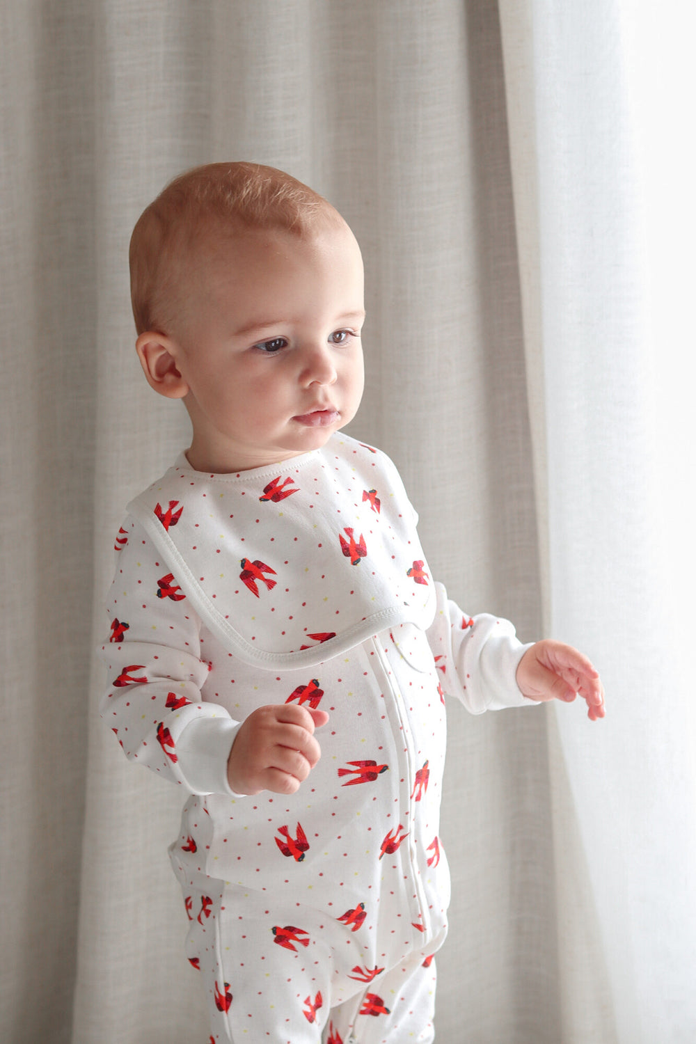 Child wearing Organic 2-Layer Reversible Bib in Red Bird.