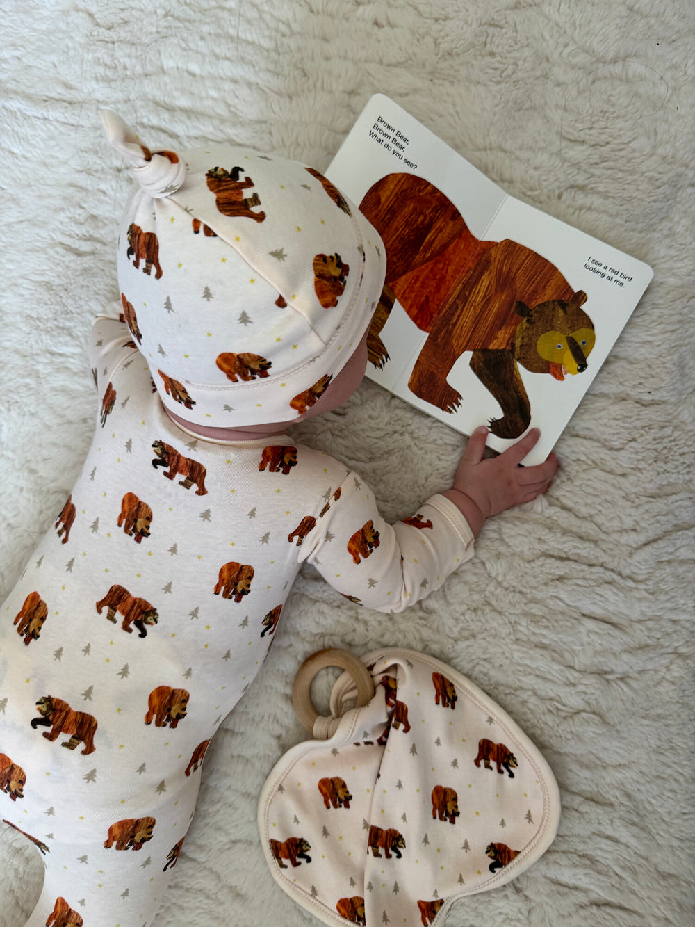 Child wearing Lovey with Removable Teething Ring in Brown Bear.