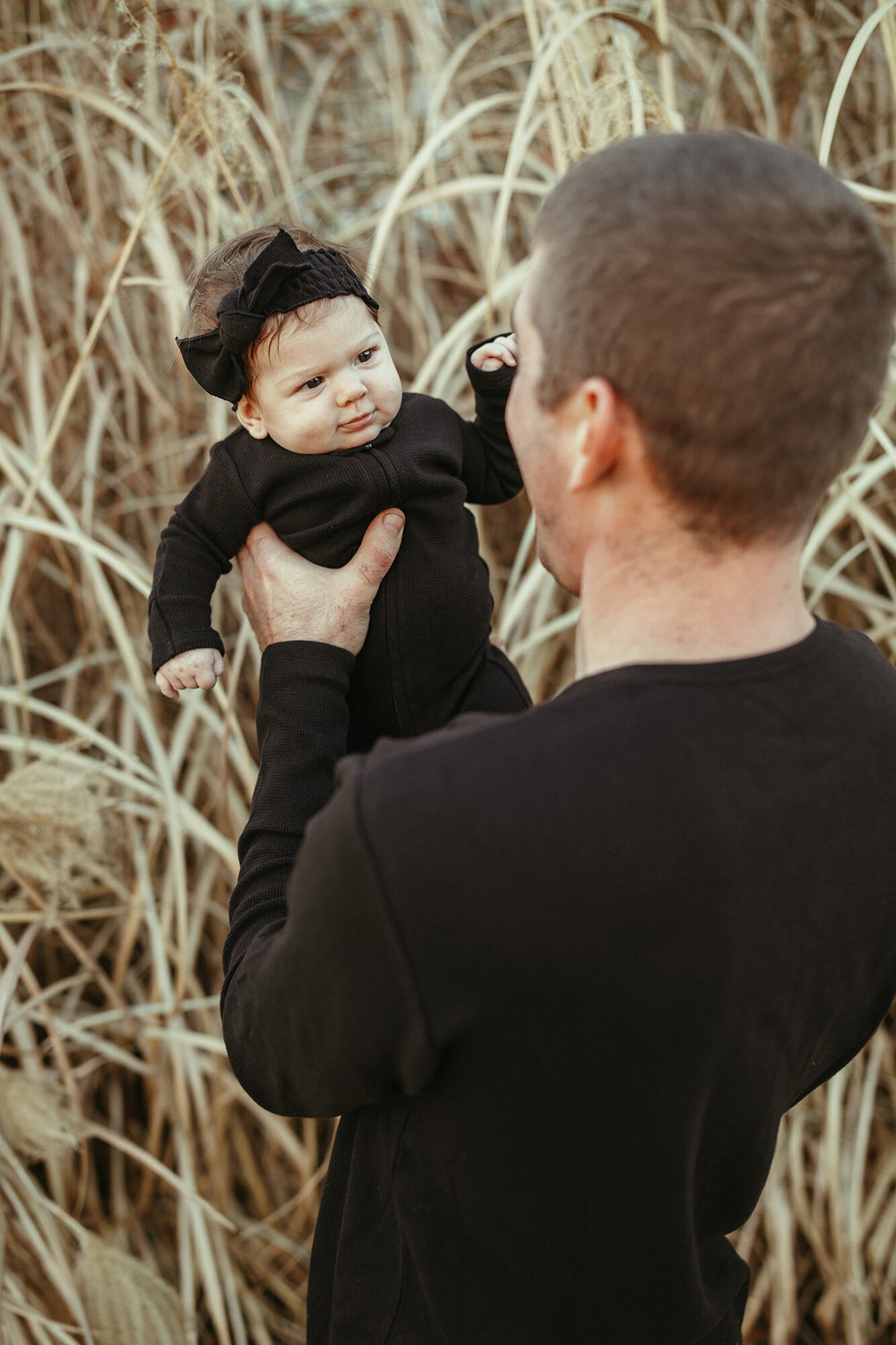 Child wearing Organic Thermal Smocked Headband in Black.