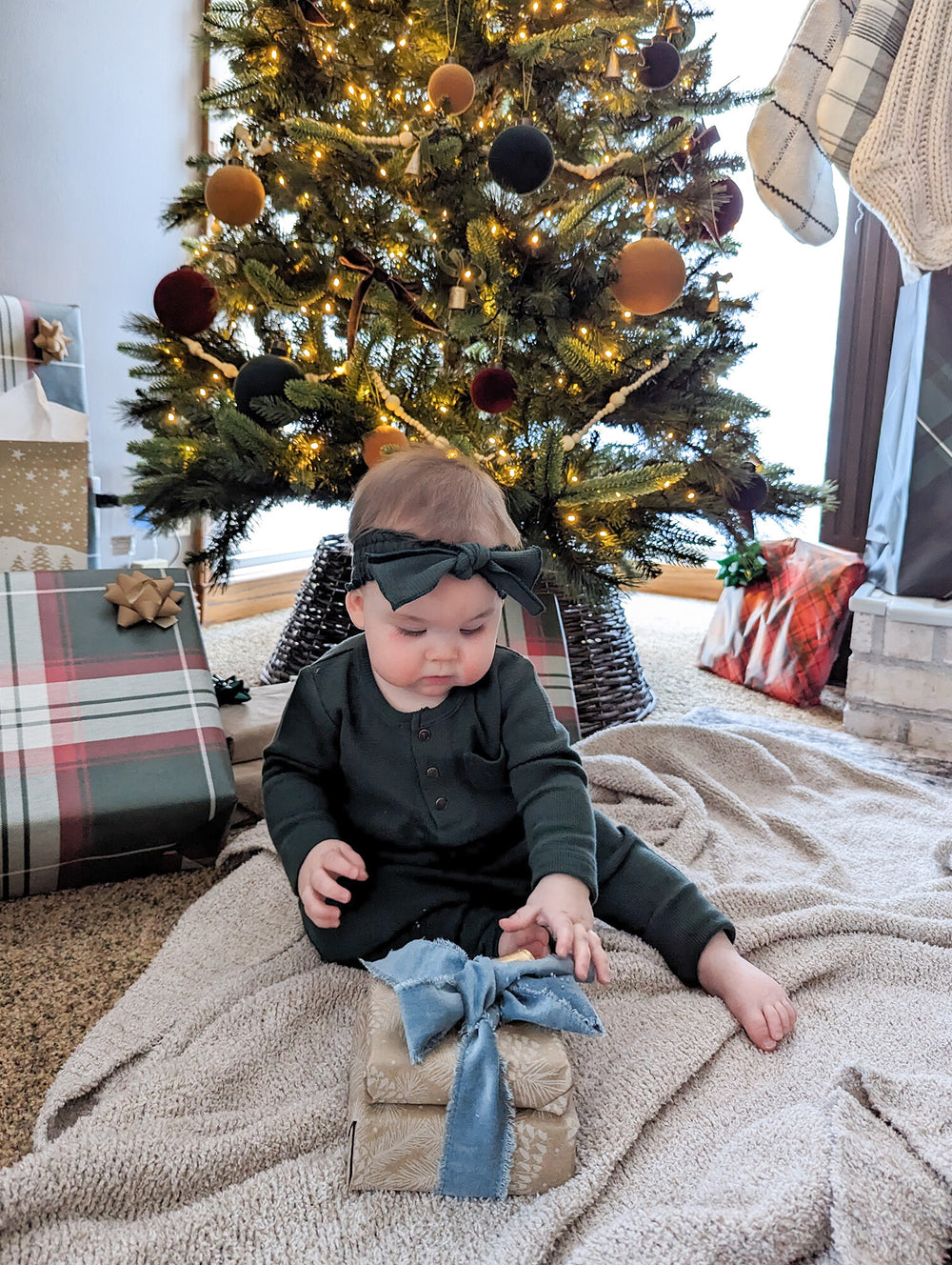 Child wearing Organic Thermal Smocked Headband in Evergreen.