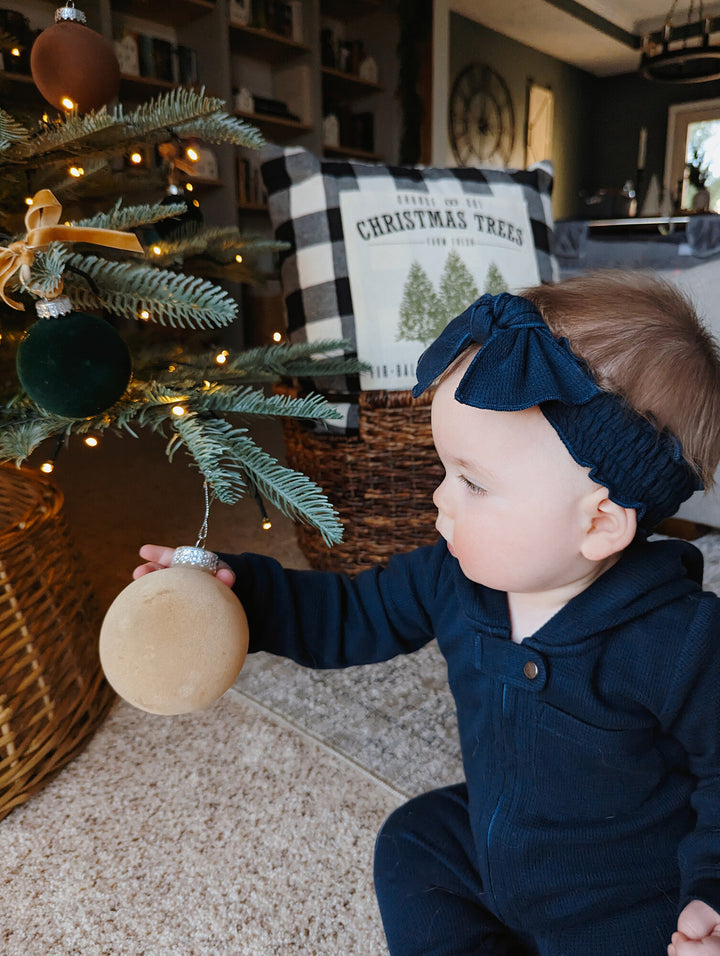 Child wearing Organic Thermal Smocked Headband in Midnight.