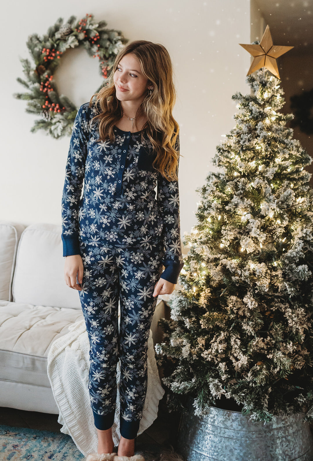 Child wearing Women's Organic Holiday 2-Pc Lounge Set with Cap in Snowflakes.