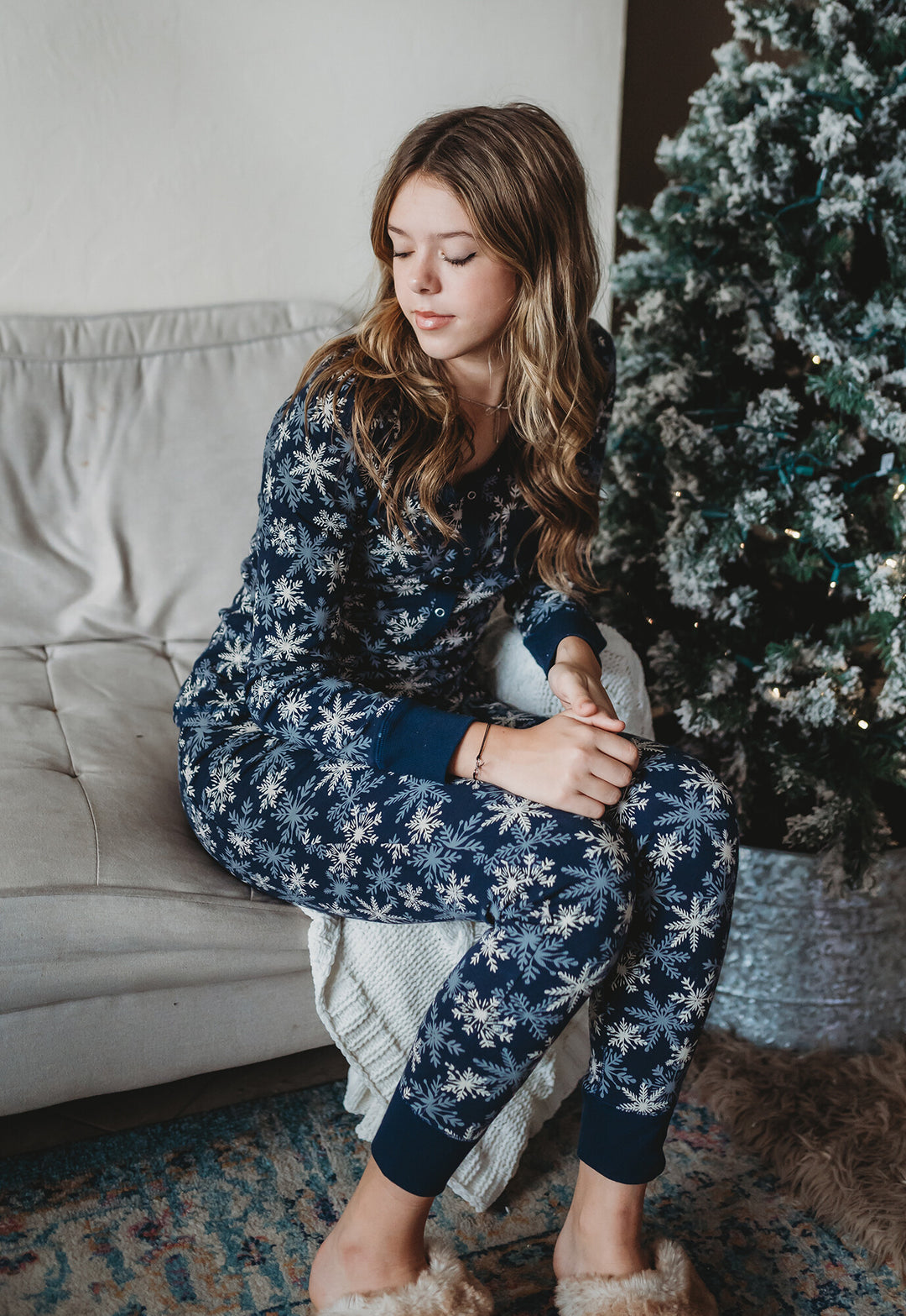 Child wearing Women's Organic Holiday 2-Pc Lounge Set with Cap in Snowflakes.