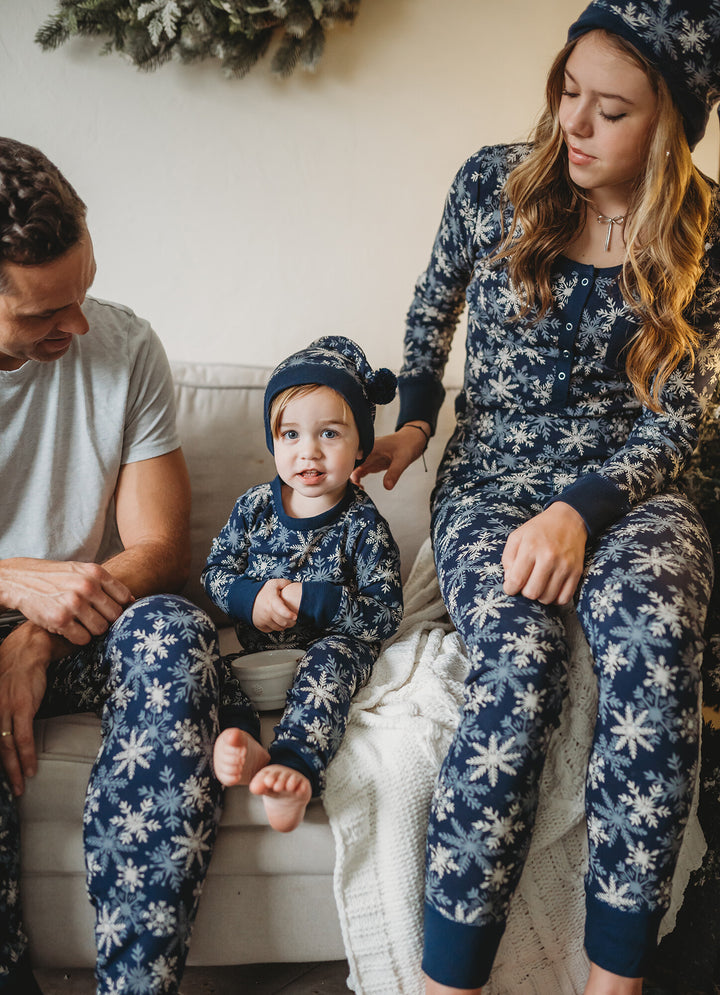 Child wearing Women's Organic Holiday 2-Pc Lounge Set with Cap in Snowflakes.