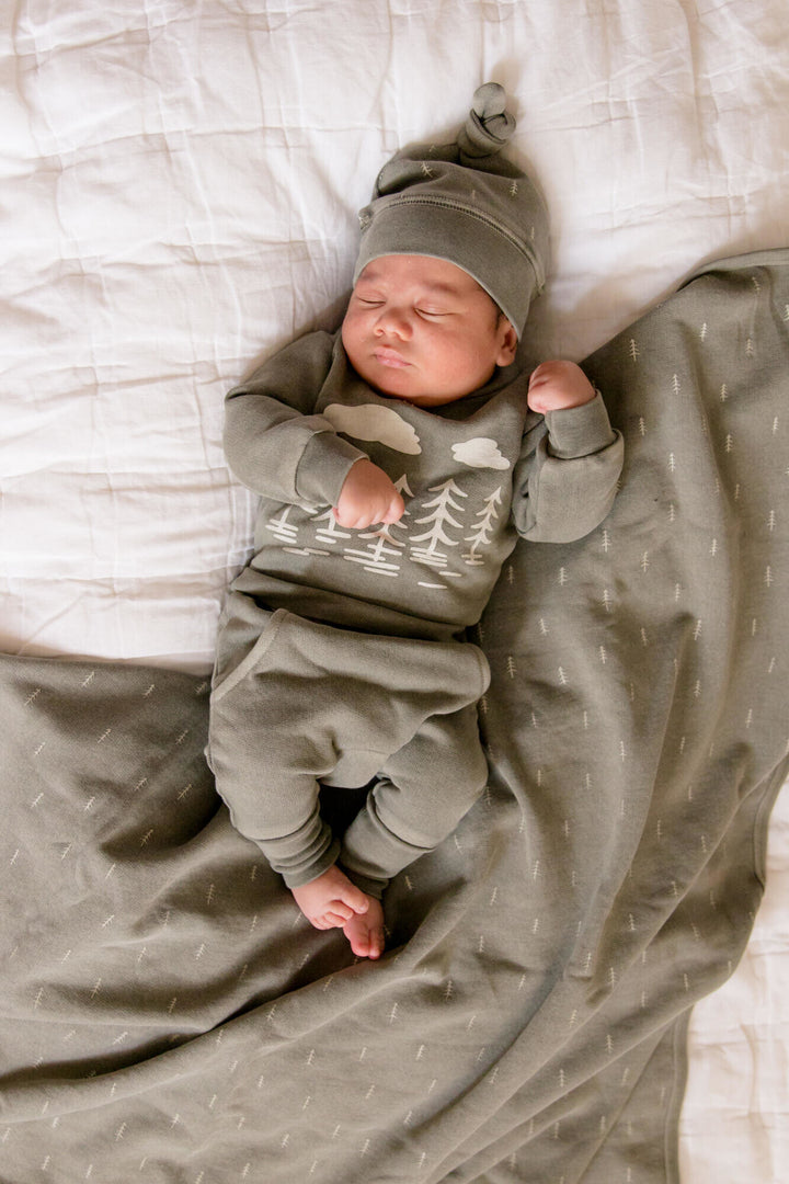 Child wearing Organic Cozy Blanket in Hunter Tree.