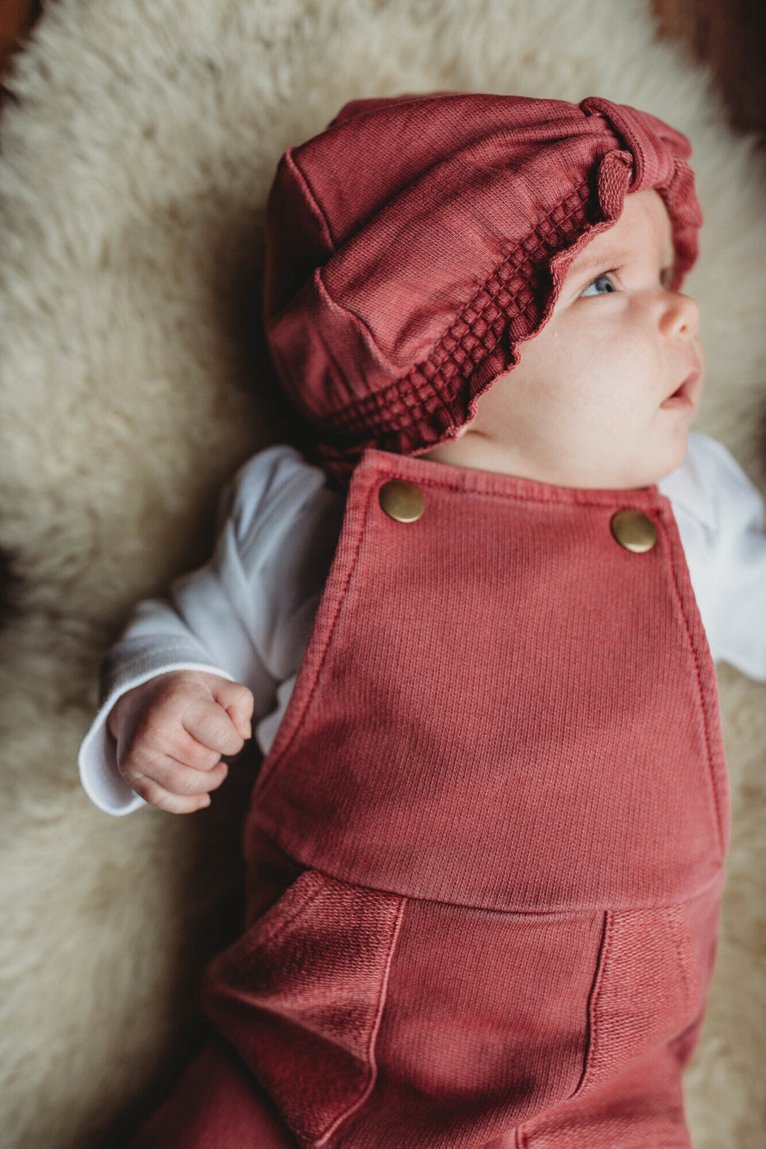 Child wearing French Terry Overall Romper in Appleberry.