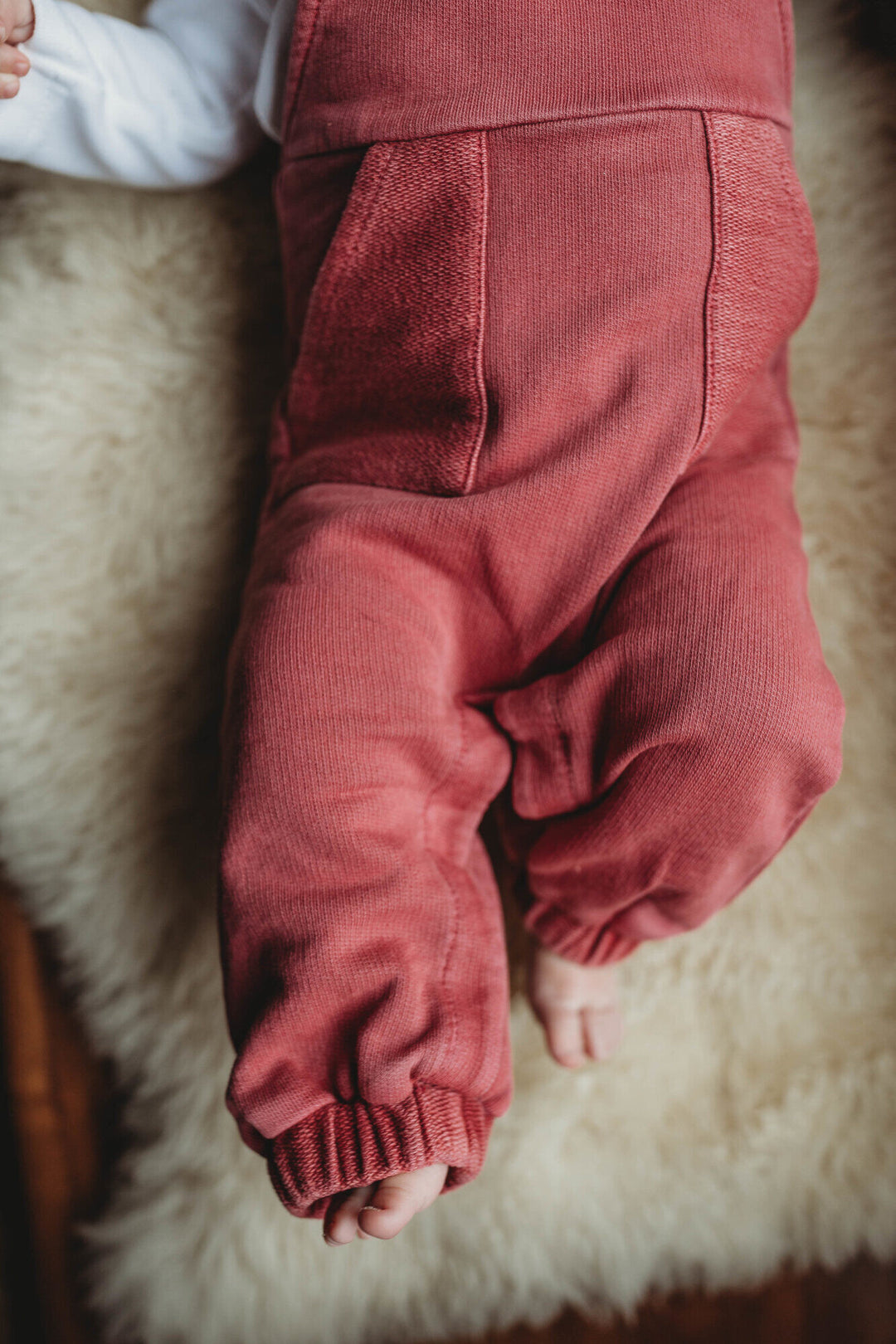 Child wearing French Terry Overall Romper in Appleberry.