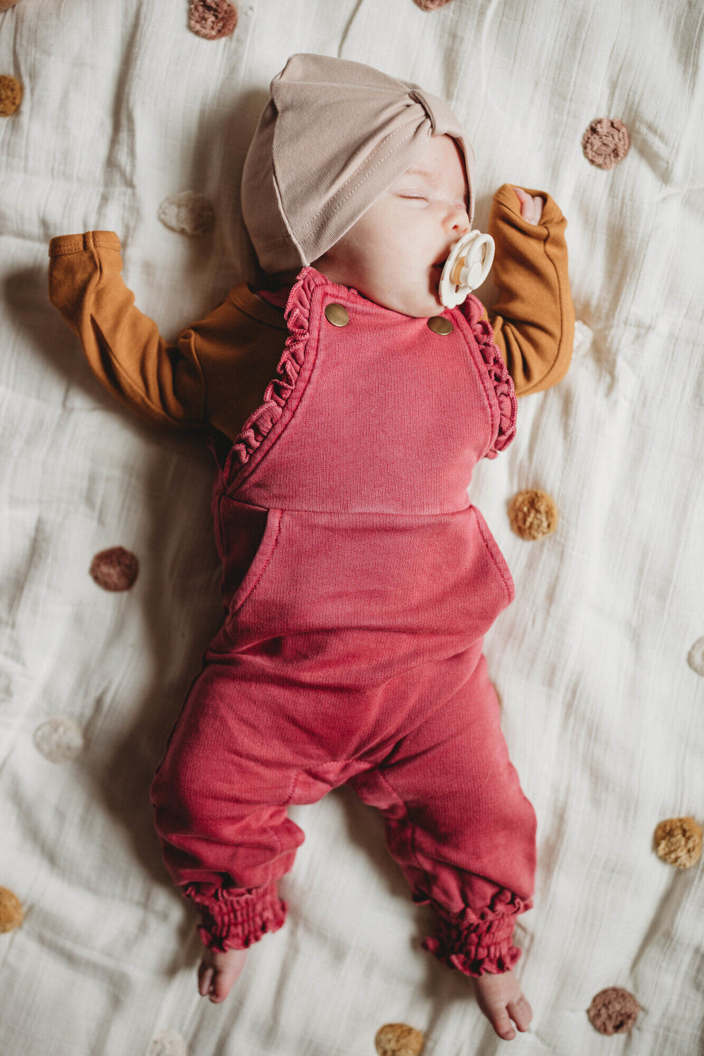 Child wearing French Terry Ruffle Overall in Appleberry.