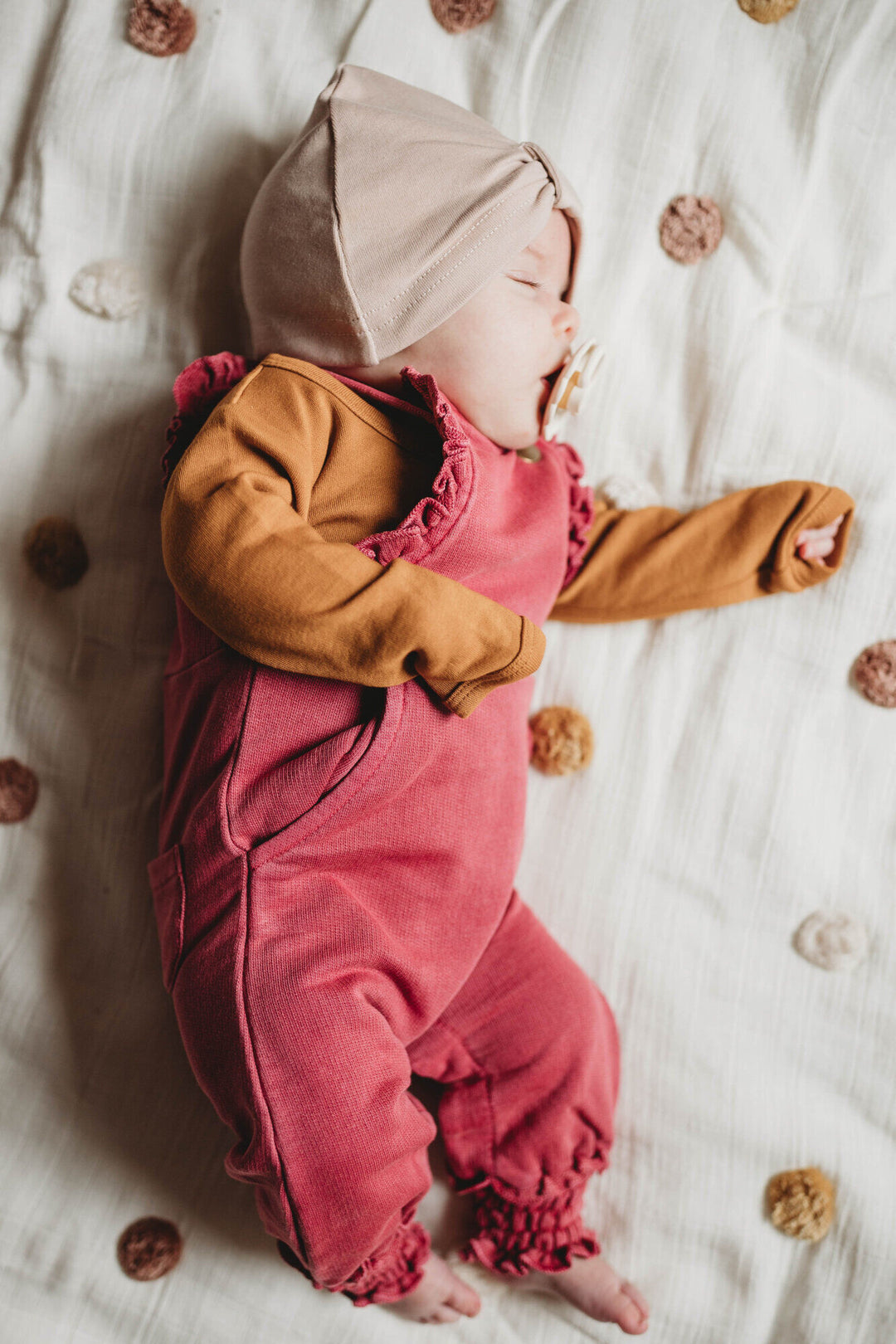 Child wearing French Terry Ruffle Overall in Appleberry.