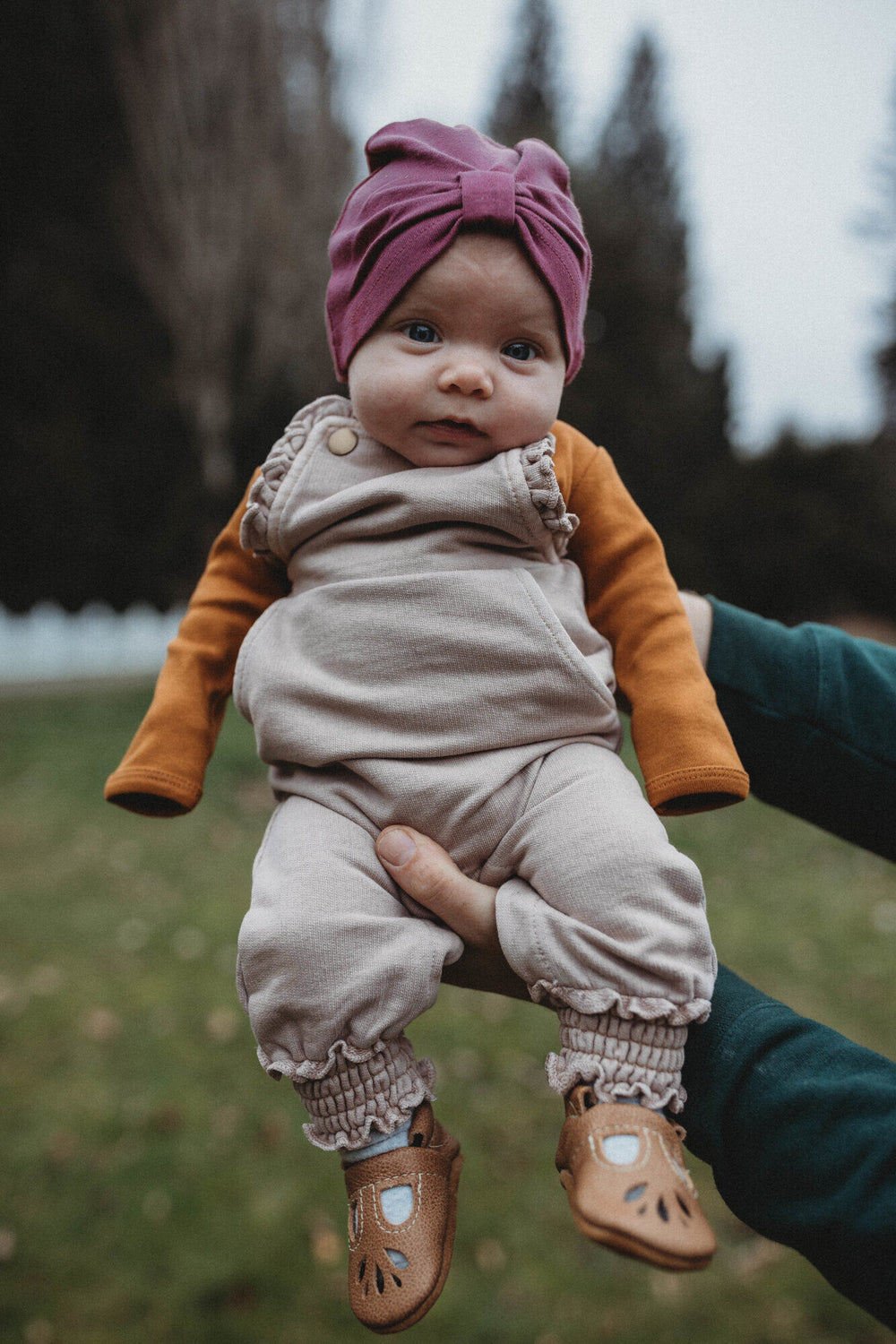 Child wearing French Terry Ruffle Overall in Oatmeal.