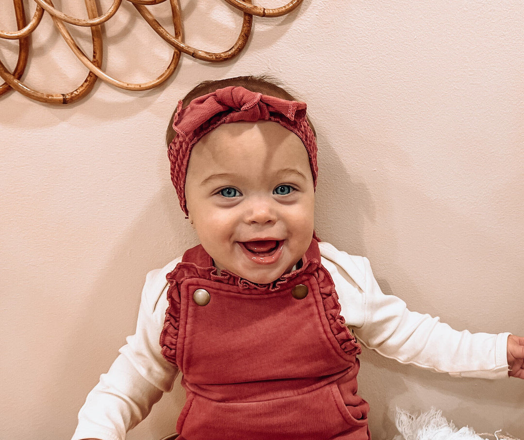 Child wearing French Terry Smocked Headband in Appleberry.