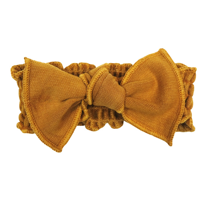 French Terry Smocked Headband in Butterscotch, a yellowish orange color.