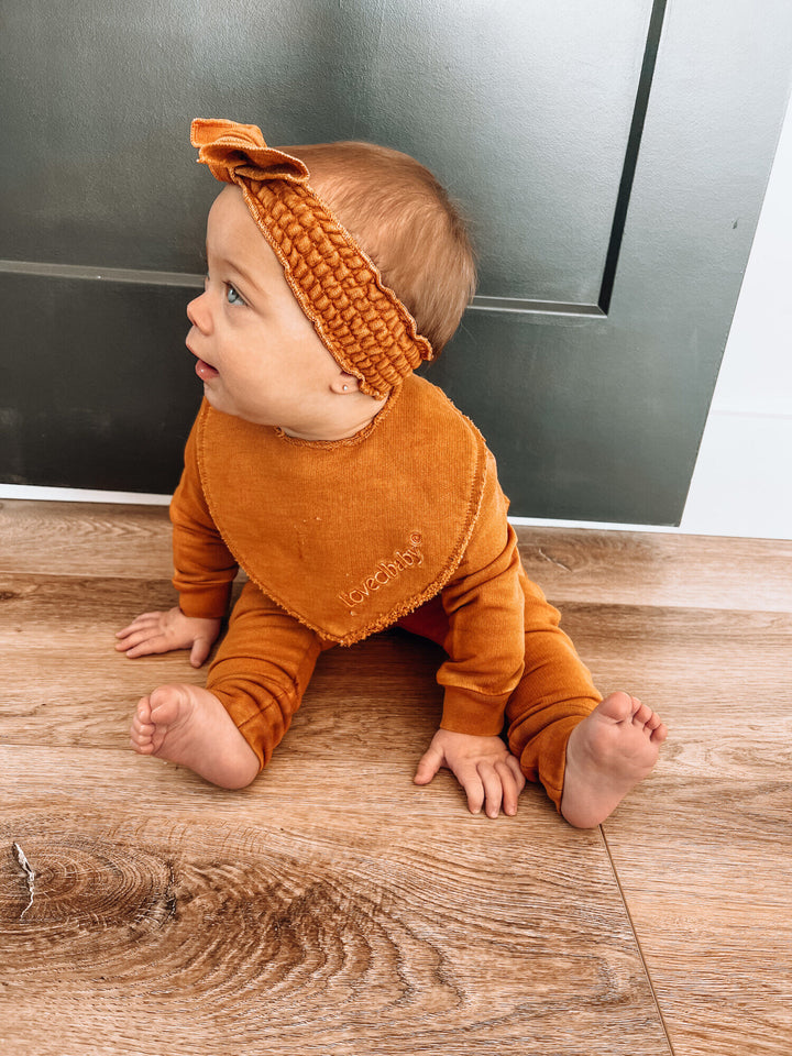 Child wearing French Terry Smocked Headband in Butterscotch.