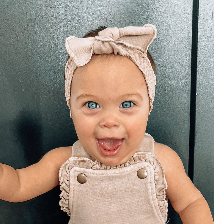 Child wearing French Terry Smocked Headband in Oatmeal.