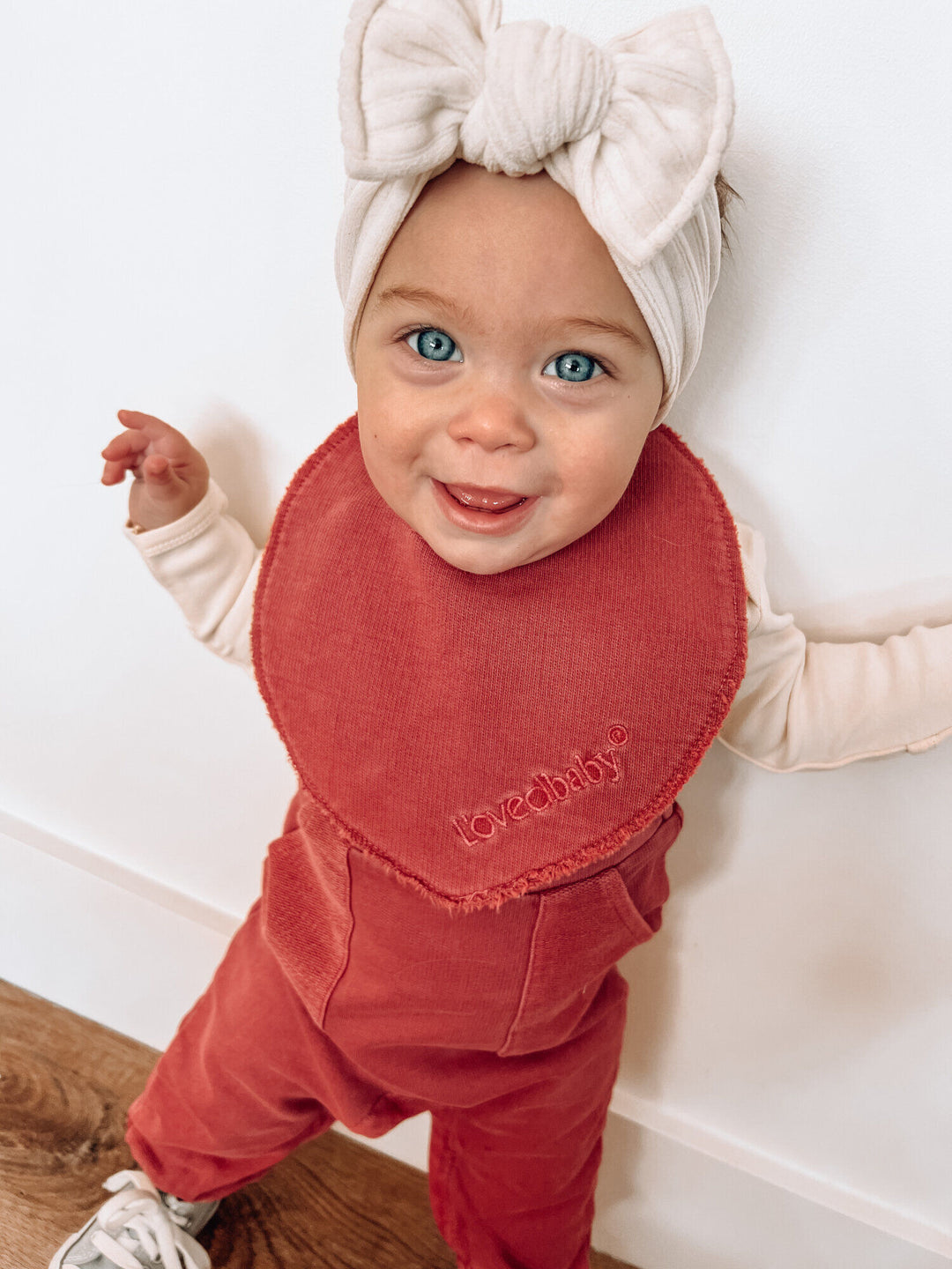 Child wearing French Terry Reversible Bib in Appleberry.