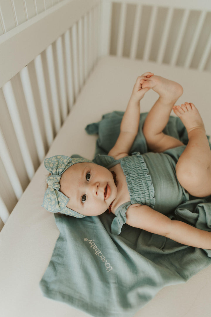 Child wearing Muslin Sleeveless Bodysuit in Sprig