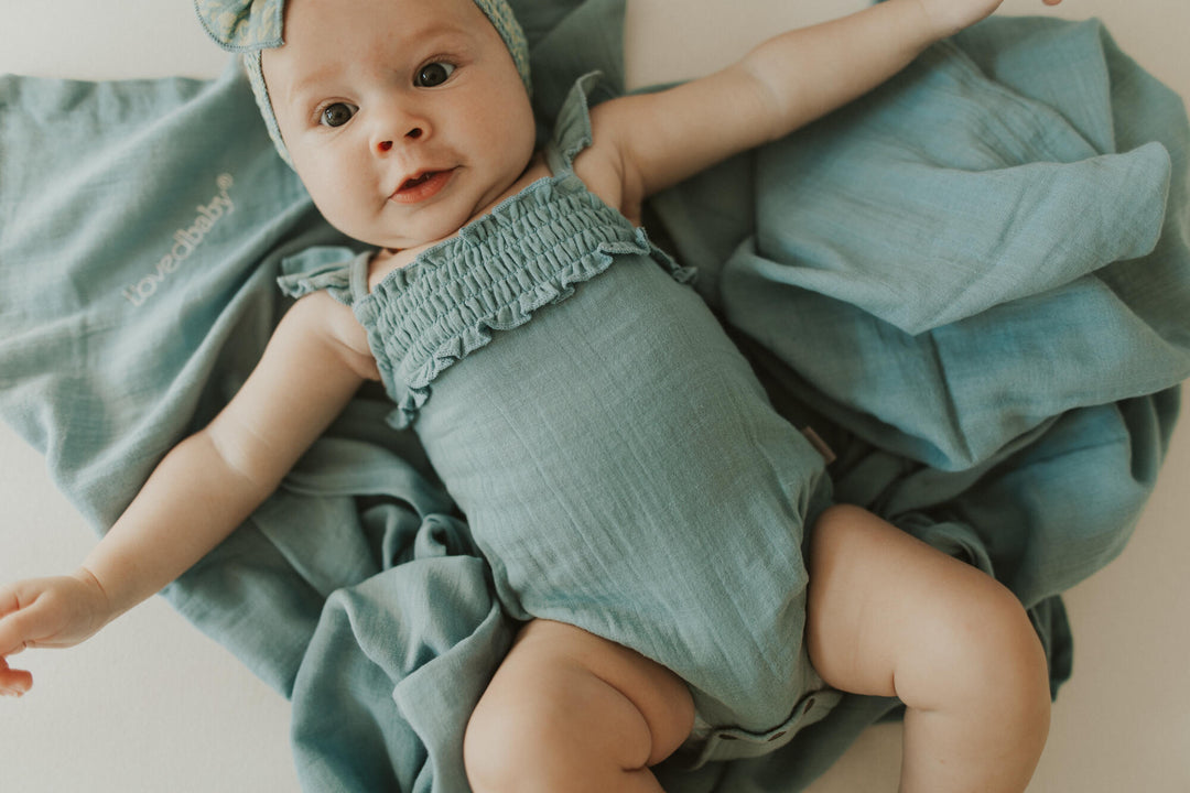 Child wearing Muslin Sleeveless Bodysuit in Sprig